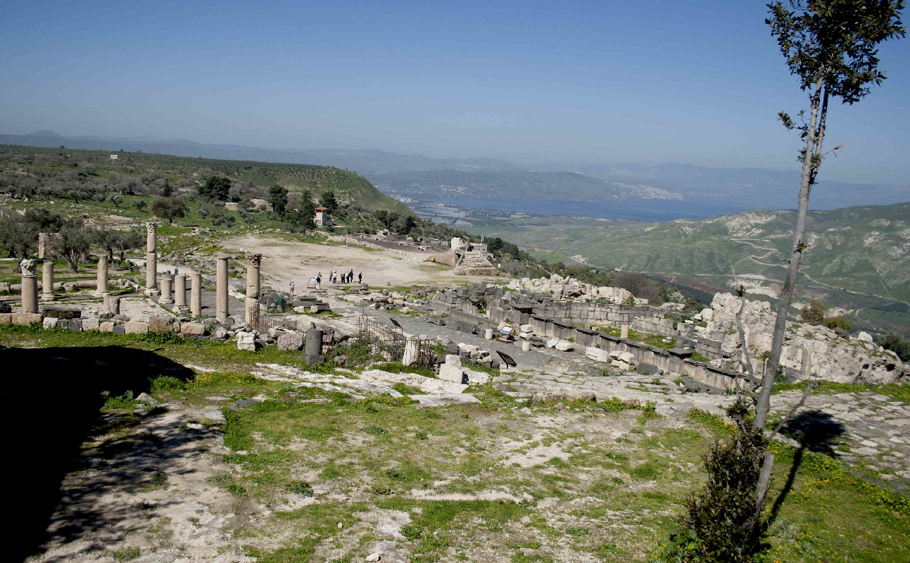 Rovine del ninfeo (in basalto) e della scala di accesso al complesso della basilica (pietra calcarea). Sullo sfondo si vedono il monte Tabor (a sinistra), il lago e la città di Tiberiade (al centro), i colli dell'alta Galilea.